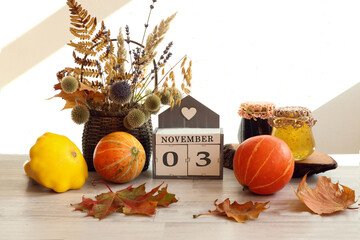 Calendar for November 3 : the name of the month in English, the numbers 0 and 3, a bouquet of dried...