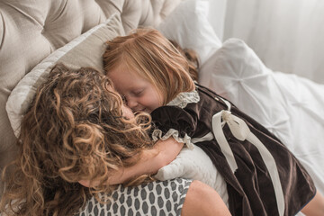Girl snuggles with mother