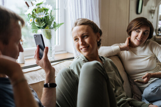Man showing smartphone screen to friends