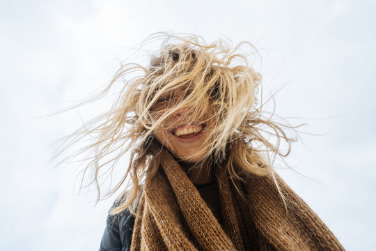 Happy woman with messy hair smiling 