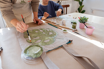 Crop mother painting on bag