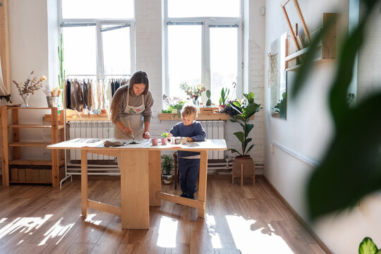 Mother and son crafting fabric bags - Powered by Adobe