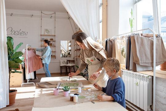 Mother and son painting in eco store