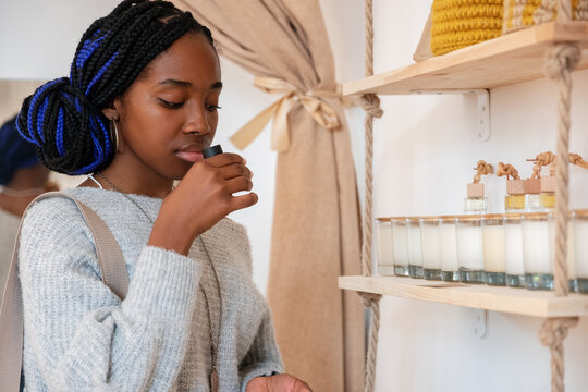 Black woman smelling natural perfume
