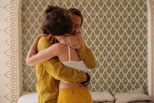 Adult couple embracing in Middle Eastern room
