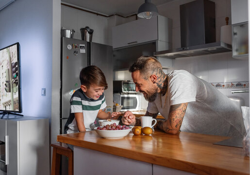 Optimistic father and son during breakfast
