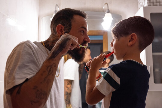 Man and boy during oral hygienic routine - Powered by Adobe