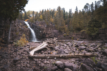 Waterfall in Gooseberry Falls State Park Minnesota, large driftwood in foreground