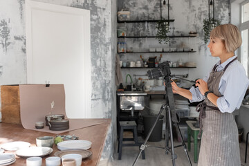 Potter with camera in workshop