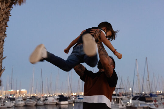 Father playing with son in dusk