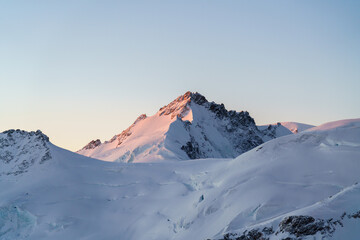 Morning light on mountain peak in the alps.