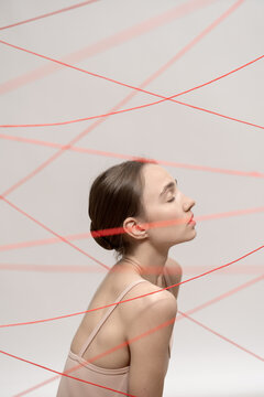Woman with red threads which symbolized control and restriction