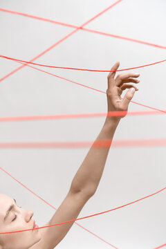 Woman with red threads which symbolized control and restriction