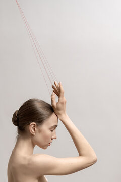 Woman with red threads which symbolized control and manipulation
