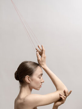 Woman with red threads which symbolized control and manipulation
