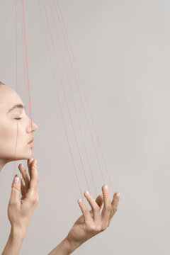 Woman with red threads which symbolized control and manipulation