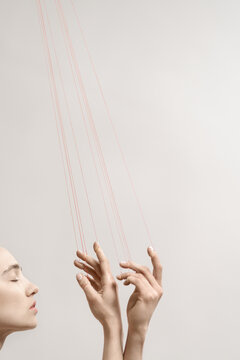 Woman with red threads which symbolized control and manipulation