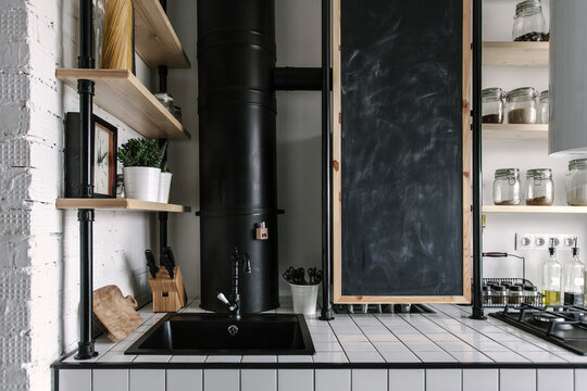 Kitchen countertop detail with a sink and blackboard