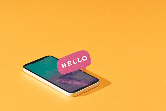 Smartphone with speech bubble on yellow background