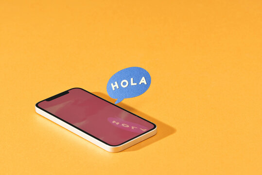 Hola, Mobile Phone with words hola in Text Bubble