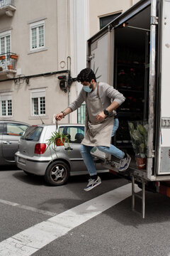 Plant shop owner jumping off the delivery truck