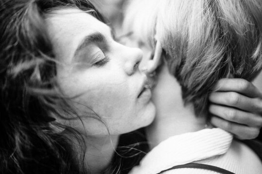 close up portrait of a young embracing lesbian couple