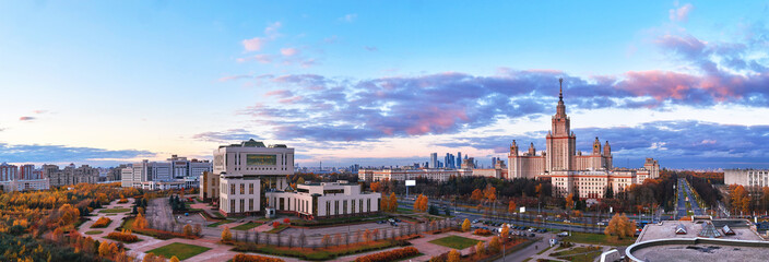 Aerial panoramic view of sunset campus of famous university under dramatic cloudy sky in autumn