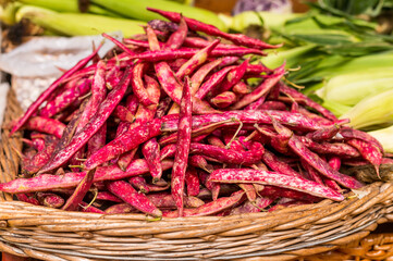 Pile of freshly harvested beans pods at farmers market. Heap of freshly picked kidney pods. Organic food concept