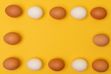 Easter eggs on a yellow background, place for an inscription in the center