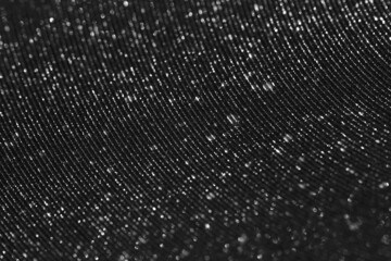 Wavy shimmering background with metallic grains of sand. Gray texture with grain and sequins close-up. Black and white silver background - 463157615