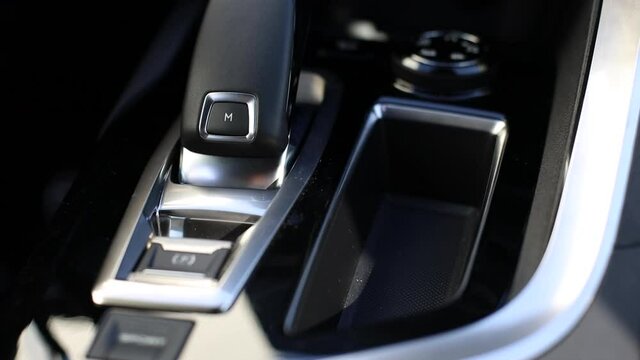 Automatic transmission, climate control and air vents in a modern car. Panning from top to bottom