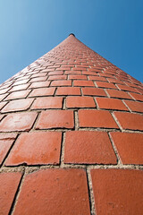 A wide angle closeup of a smokestack at an old factory, now retired.