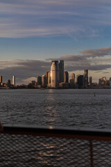 Ferry to Manhattan. View of Manhattan from the water at sunset, New York, USA