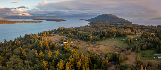 Aerial Sunset View of Lummi Island, Washington. Beautiful autumn evening in the Salish Sea with the city of Bellingham in the background.