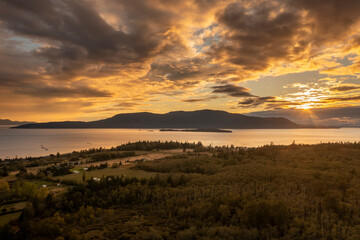 Dramatic Aerial Sunset View of Orcas Island Washington. With Lummi Island in the foreground the sun sets on this gorgeous autumn evening in the Salish Sea area of Washington state.