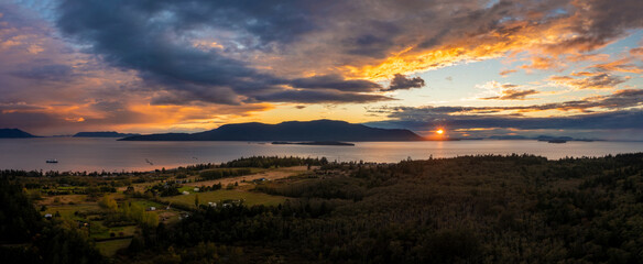 Dramatic Aerial Sunset View of Orcas Island Washington. With Lummi Island in the foreground the sun...