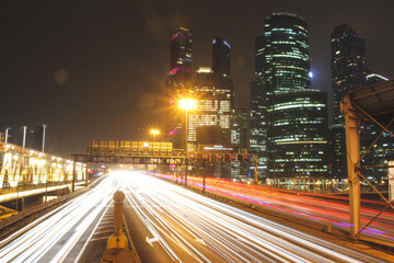 tracers of traffic on highway in the downtown at night
