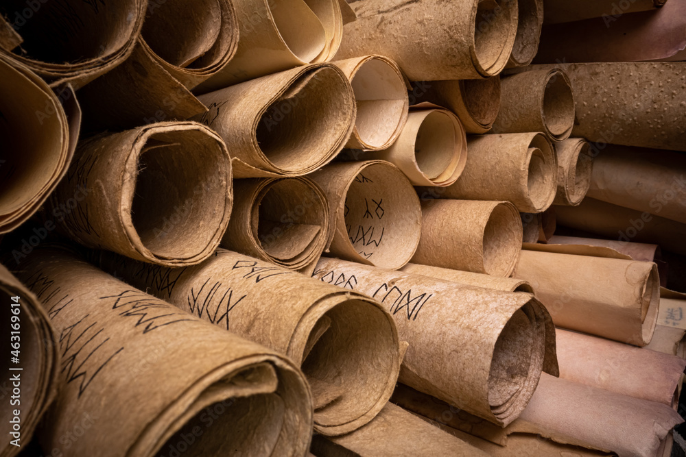 Poster ancient scrolls stacked on pile. old scroll library.