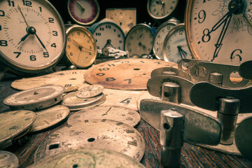 Old watchmakers workshop with spare parts and broken clocks