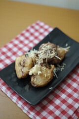 Fried banana topping chocolate, milk and cheese. Popular snack in Indonesia.