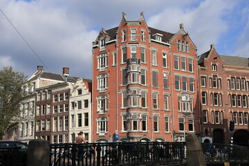 Fototapeta na wymiar Amsterdam Raadhuisstraat Street View with Buildings and Canal Bridge, Netherlands