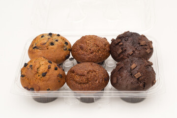 Blueberry, bran and chocolate chunk muffins in plastic container