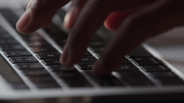 Close up of hands typing on a keyboard