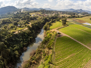 Farm with houses, river and plantation