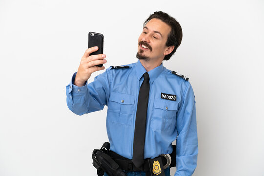 Young police man over isolated background white making a selfie