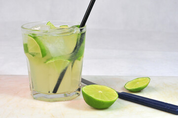 shot of cozumel, margarita, tequila drink with lemon in the glass on the table, horizontal image with blurred background