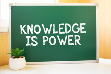 Knowledge is power in chalk on the school board, Search engine optimization and websites. Desk, swept balls of paper, computer keyboard