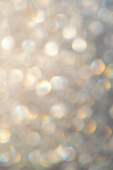 bright glitter background: bokeh effect from many colored lights on frozen glass, toning