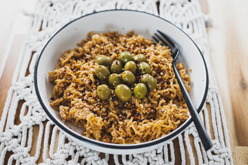 vegan ginger noodles with chilli flakes and coriander seeds topped with olives and breadcrumbs, healthy plant-based food