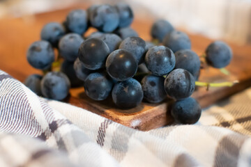 Concord Grapes on a wooden cutting board 